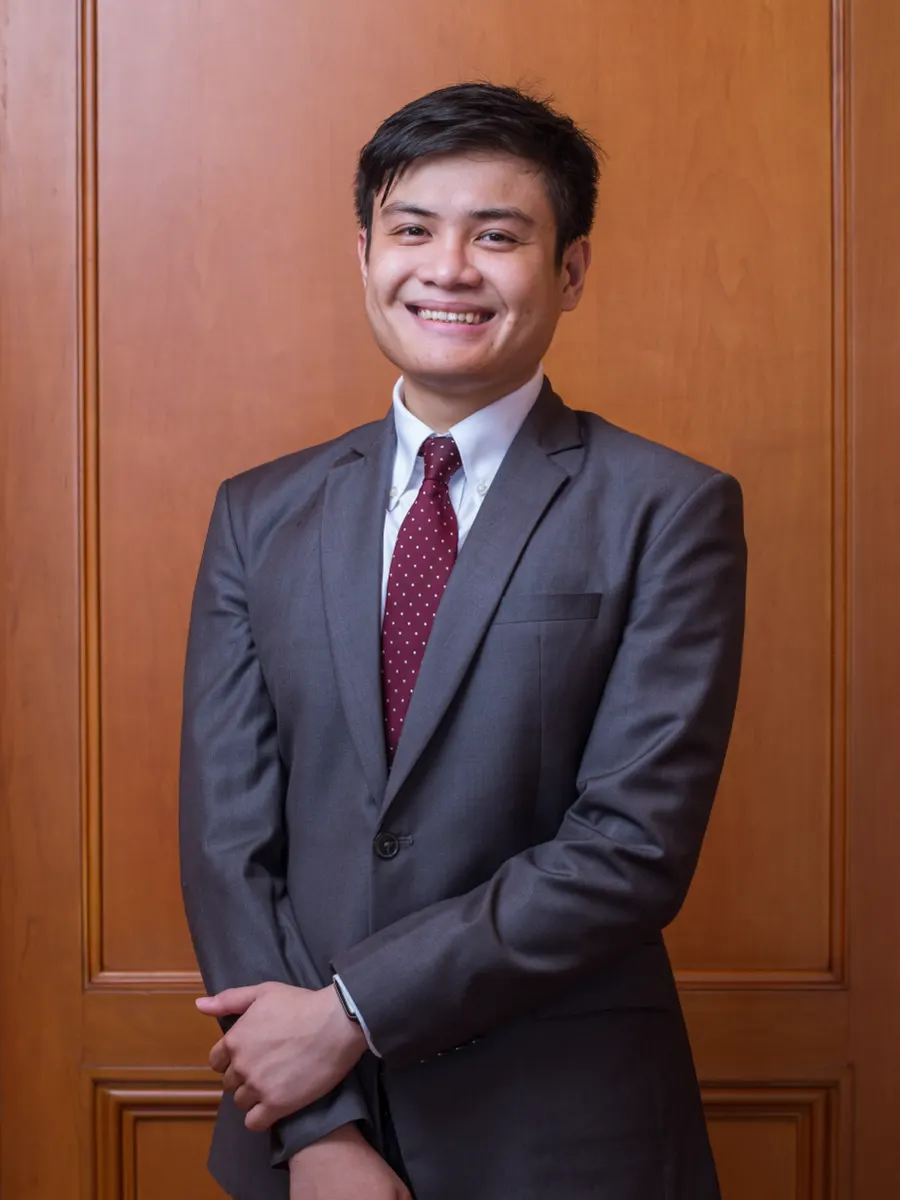 Portrait of Edward P. Martinez in a gray suit and maroon tie
